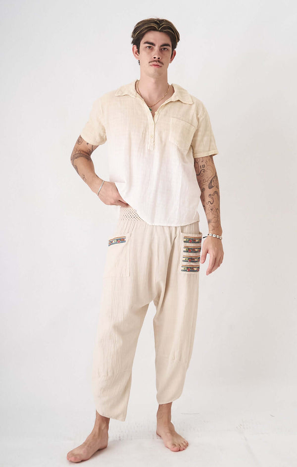Minimalist pastel cream men's oversized shirt with artistic details and breathable fabric.